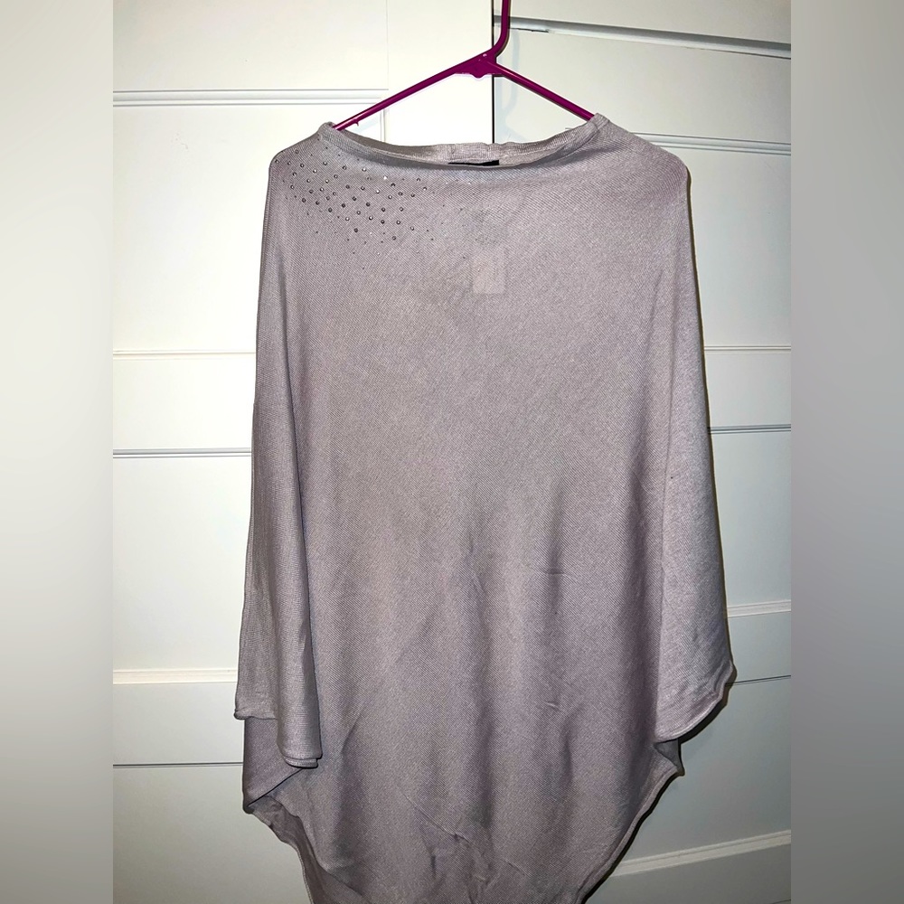 Women’s cape with rhinestone detail on shoulder from Fraas.